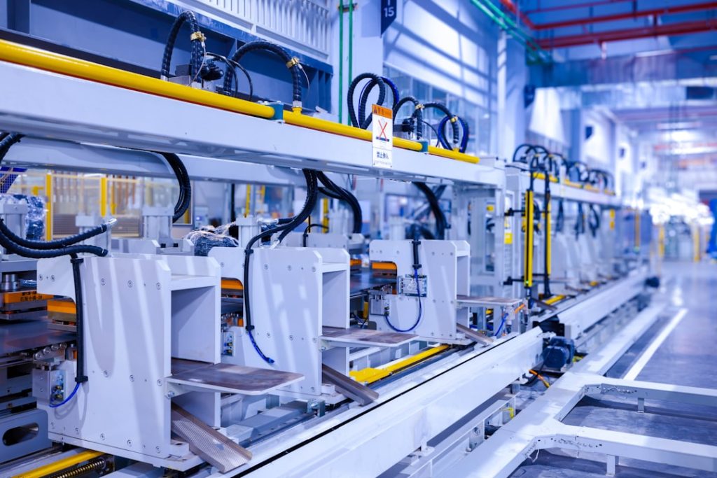 Industrial production line of a refrigerator manufacturing plant Translation: WARNING Danger! Prohibit reach into