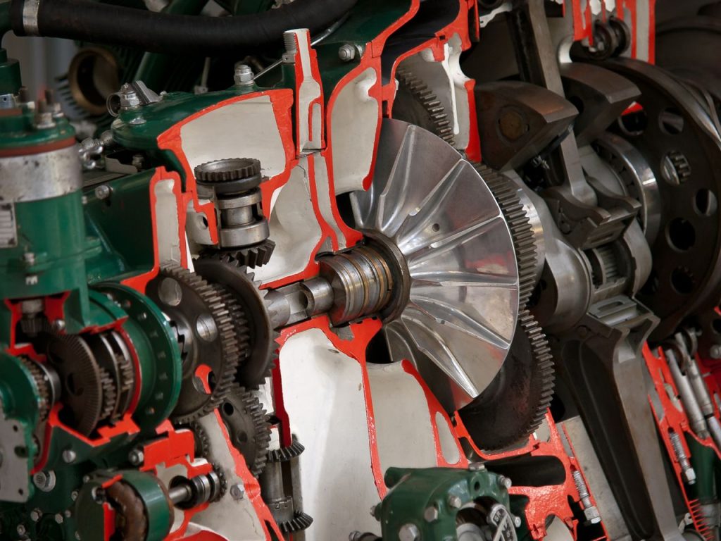 Detailed view of industrial machinery showcasing gears and cogs inside a mechanical system.